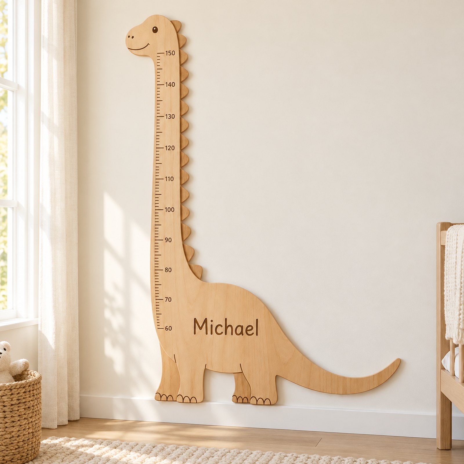 Michael dinosaur chart hanging in a nursery