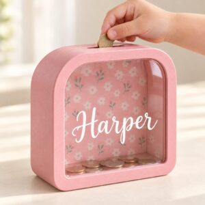 Child hand inserting a coin into the Harper bank